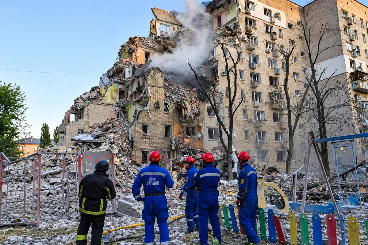 Rescue workers stand among the rubble of a heavily damaged apartment building following a Russian attack on Kyiv, Ukraine.