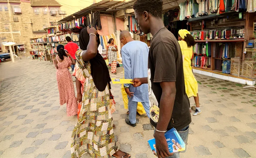 Senegalese youth giving campaign book