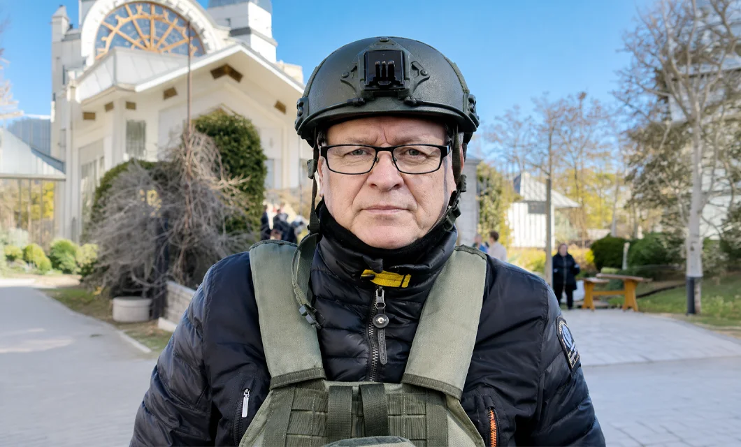 Dr. Hannu Haukka wearing a helmet, pictured near the front lines in Ukraine.